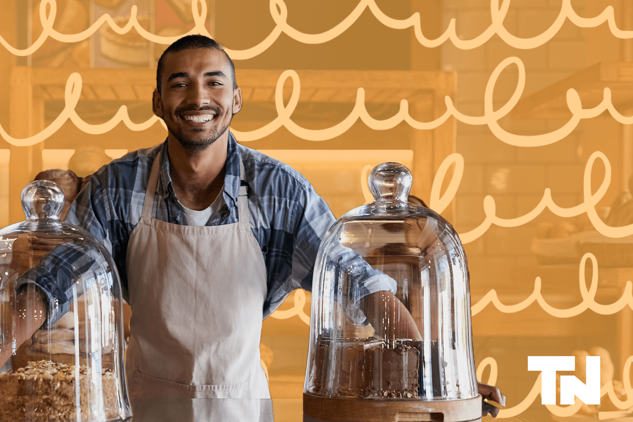You African American man stands in front of the counter of his coffee shop. He has mastered using Sales per labour to run his restaurant.