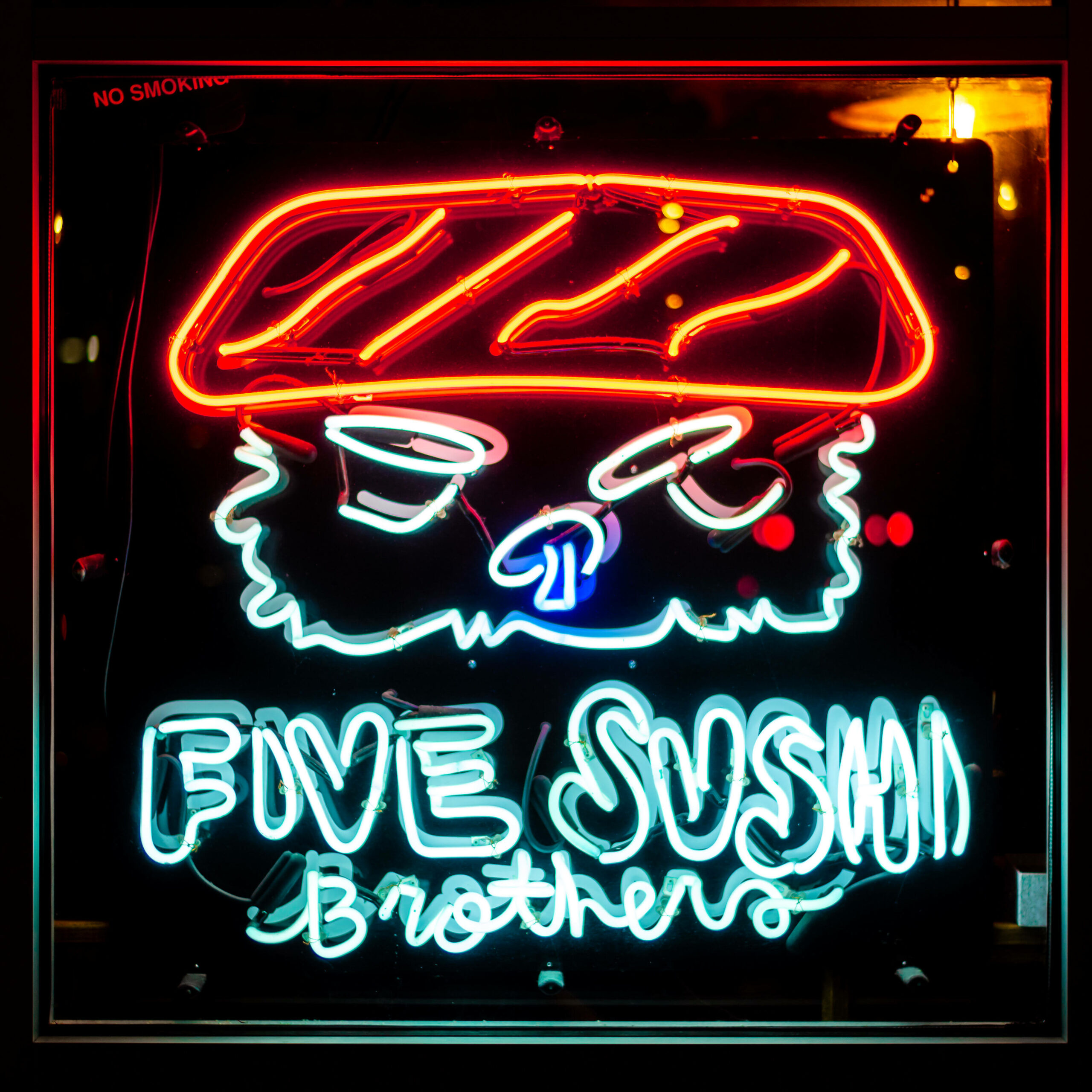 Neon sign of the Five Sushi Brothers logo