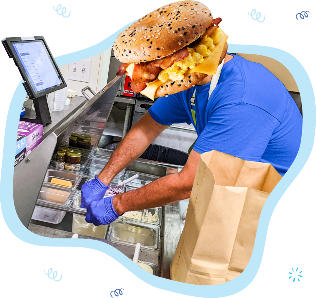 Stay cool and organized even at the height of your rush with a customized KDS. A man with a bagel head uses his KDS to take orders.