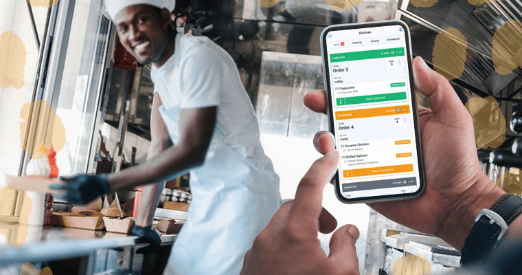 In a bustling food truck, a young African American cook smiles as he hands a freshly prepared order to a customer, while a mobile KDS on a phone manages orders nearby.