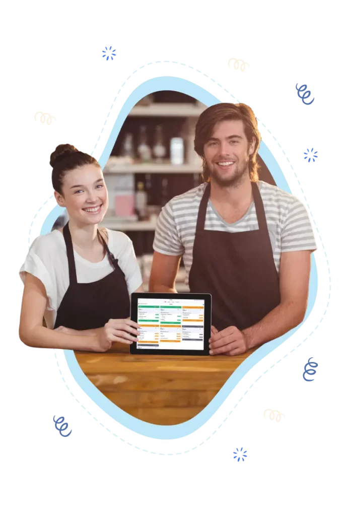 Joyful image of a young male and female coffee shop owner team, proudly holding a tablet featuring Table Needs' built-in Kitchen Display System (KDS). Elevate your quick service restaurant with streamlined kitchen operations, electronic communication between staff, efficient ticket routing, and customer alerts for order readiness. Experience the ultimate in speedy and accurate service for a successful dining experience.